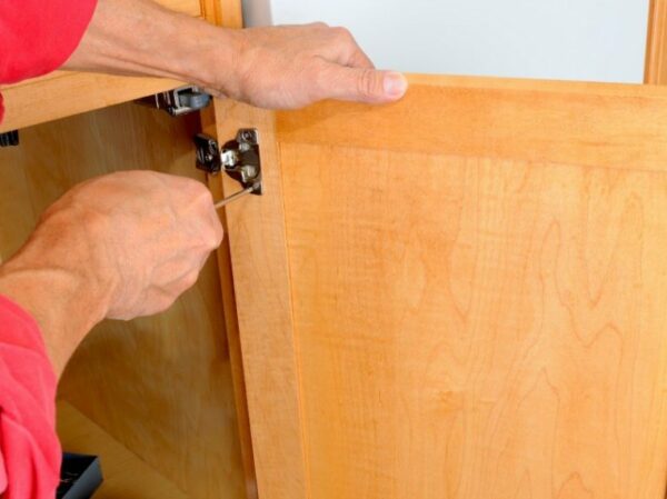 Picture of contractor adjusting door